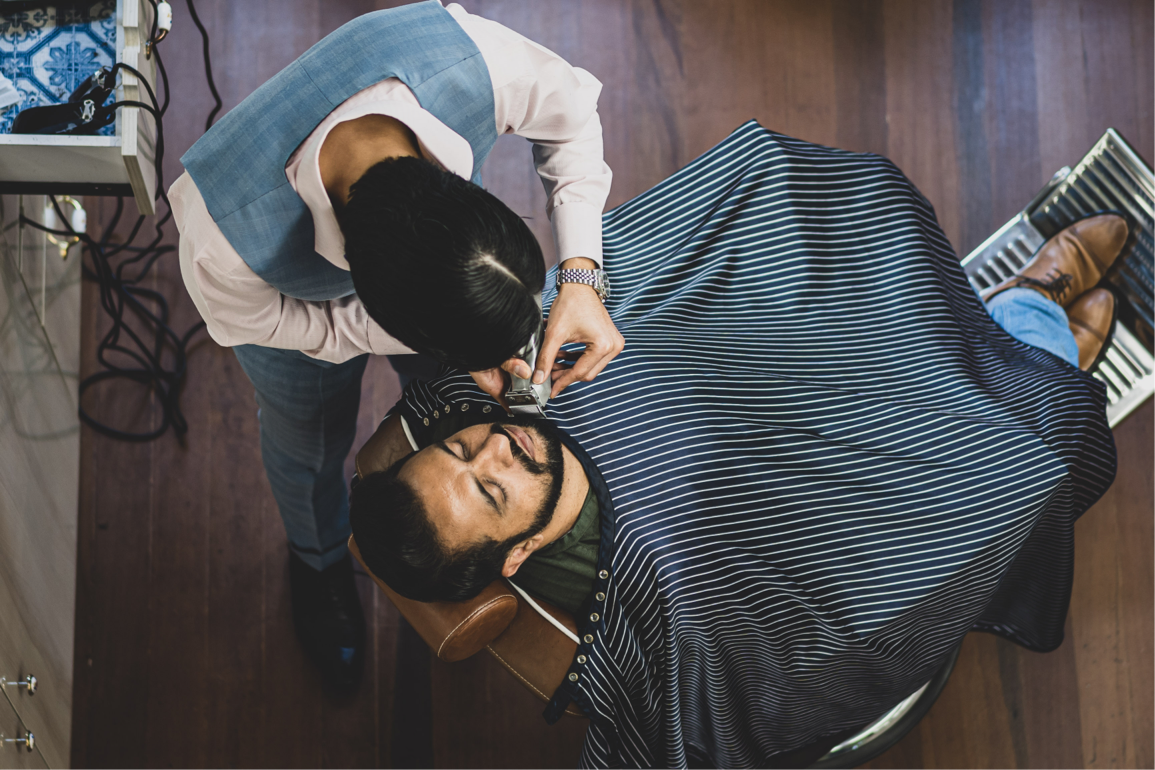 man getting a shave by a barber